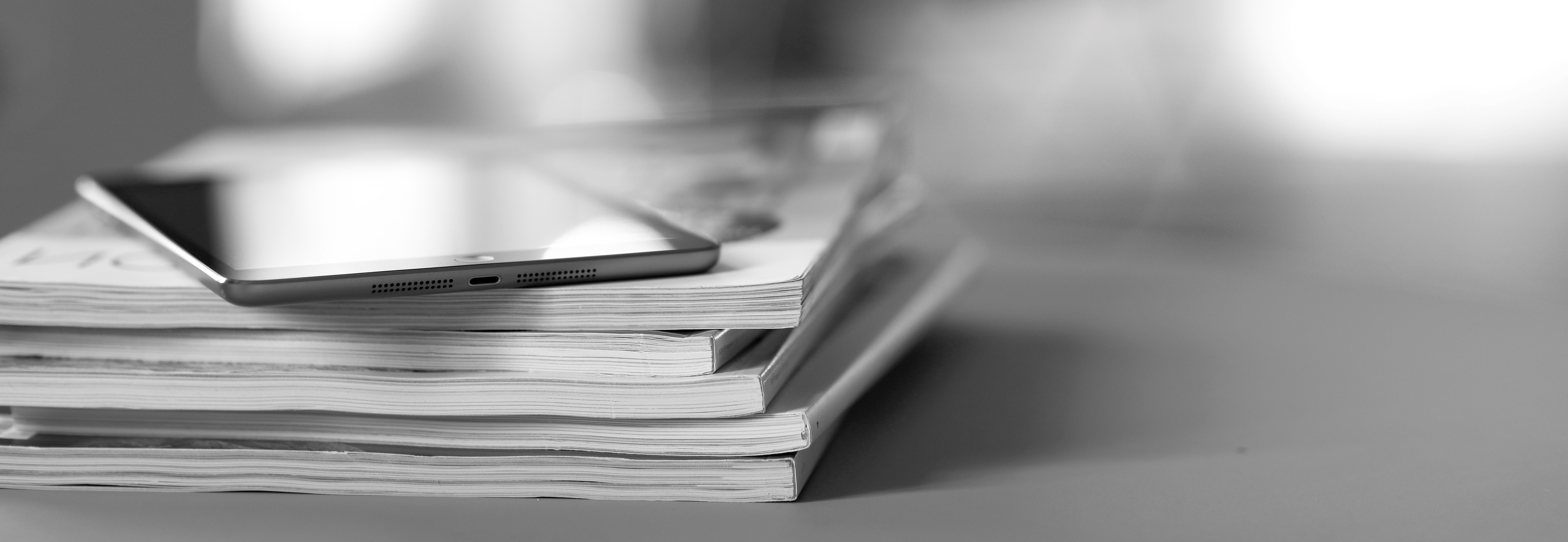 Tablet device on a stack of magazines