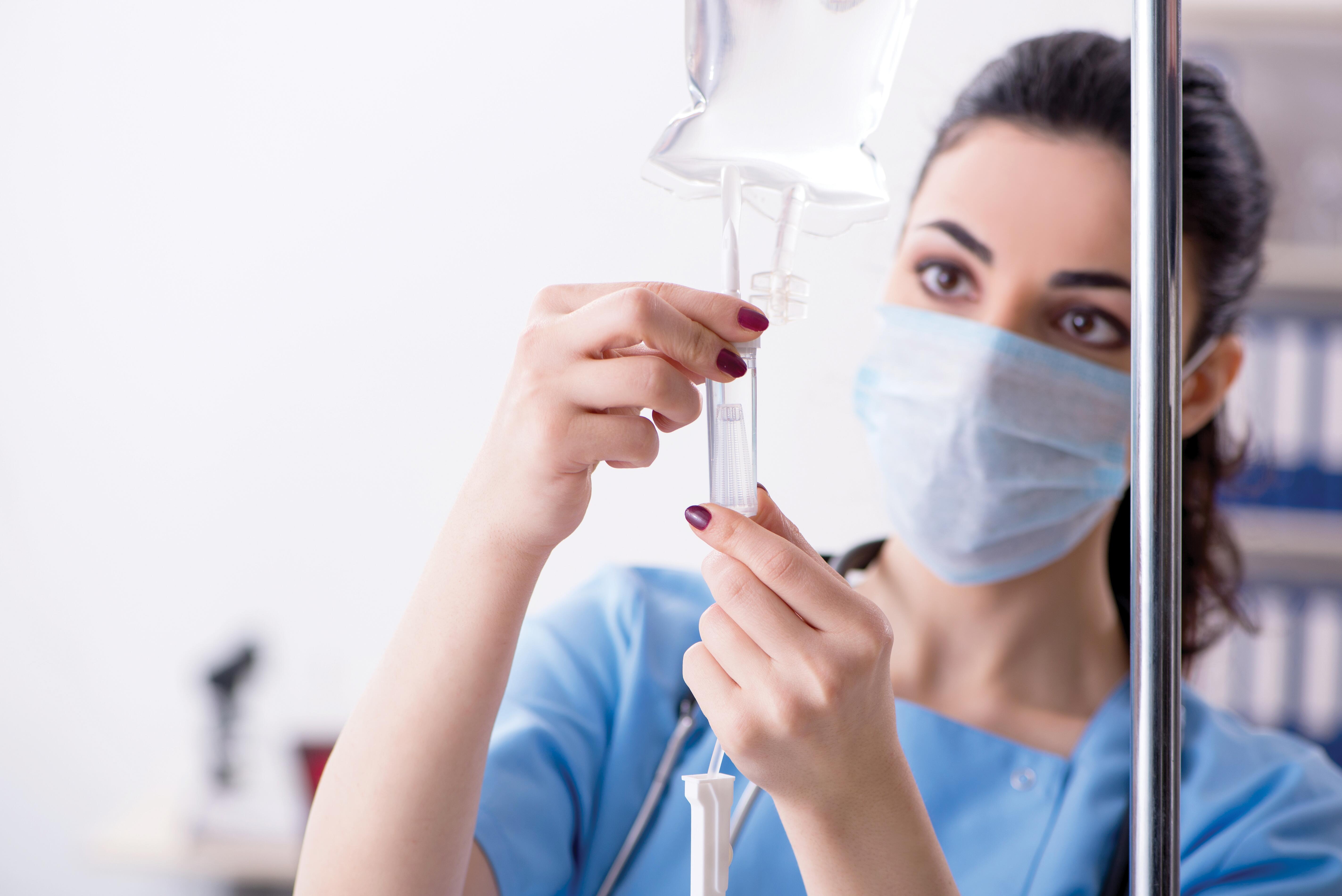 Nurse prepping infusion